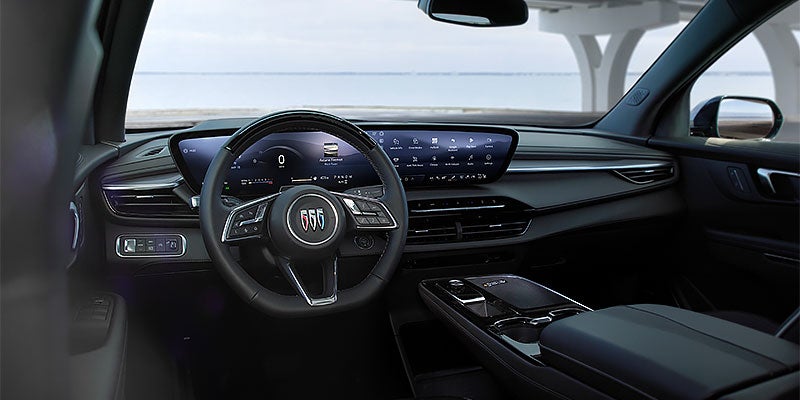 Modern Buick vehicle interior featuring a steering wheel, digital instrument cluster, touchscreen infotainment display, and center console