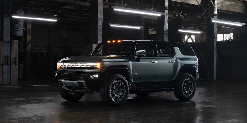 GMC HUMMER EV SUV parked inside an industrial-style facility, showcasing its rugged electric off-road design