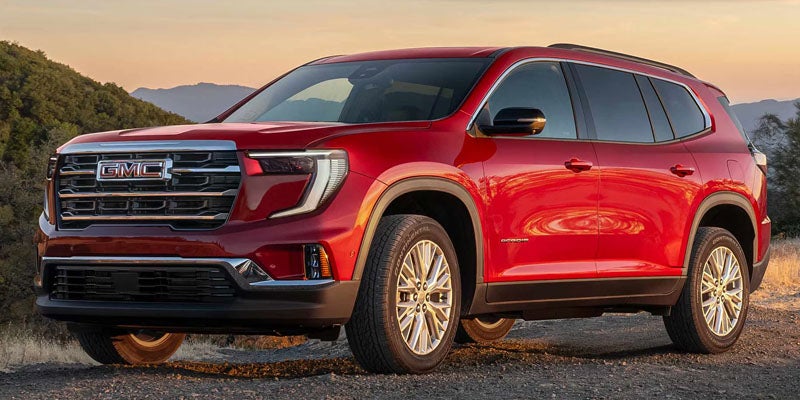 Large red SUV with GMC branding on the front grille